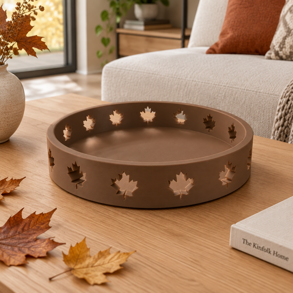 Solid brown round Autumn Tray with maple-leaf cutouts on an autumn coffee table