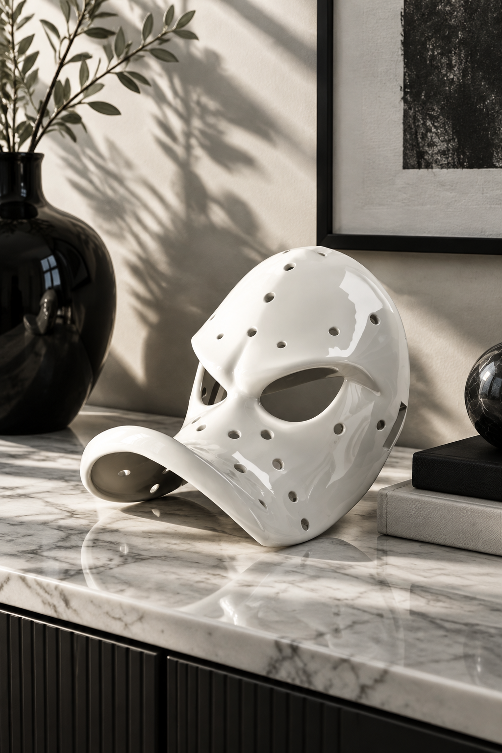 White perforated Duck Bill Mask on a marble sideboard with monochrome décor