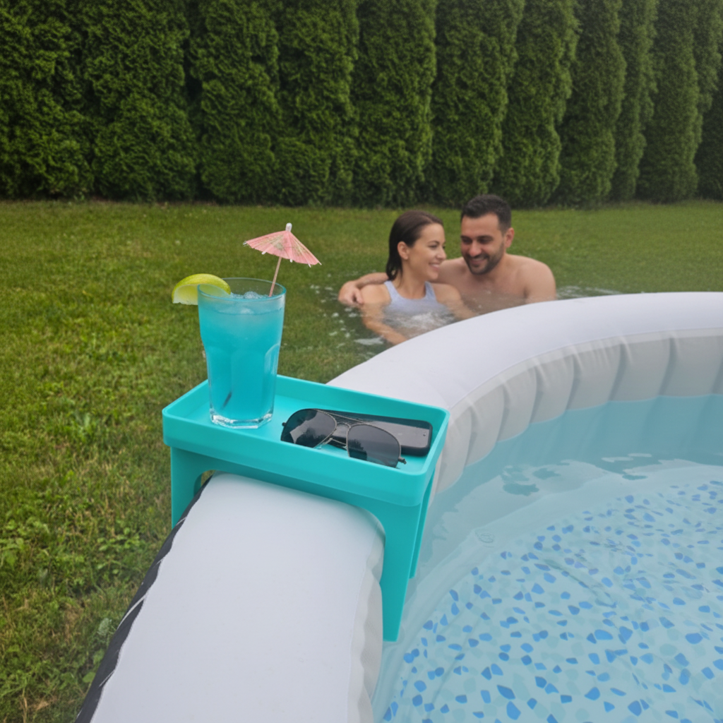 Blue hot tub caddy clipped onto Lay-Z-Spa hot tub holding cocktail glass, phone and sunglasses with couple relaxing in background