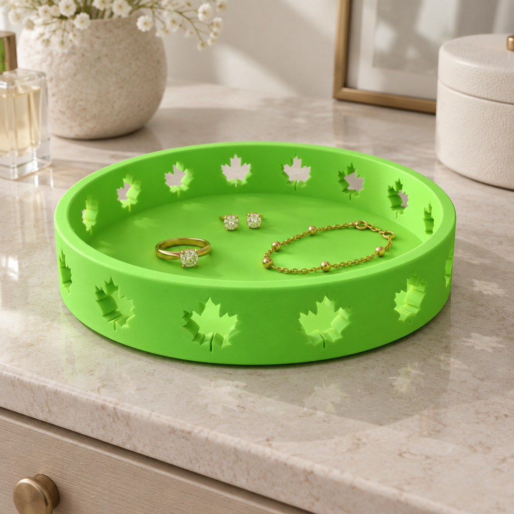Solid neon-green round Autumn Tray with maple-leaf cutouts on a pale stone dresser