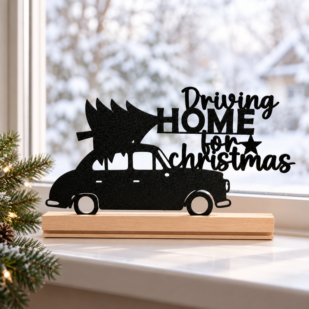 Black Driving Home for Christmas Sign on an indoor windowsill in winter