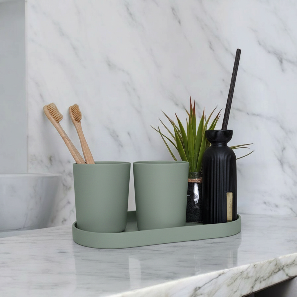 Sage green calm sink set on marble bathroom counter with bamboo toothbrushes, succulent and soap dispenser