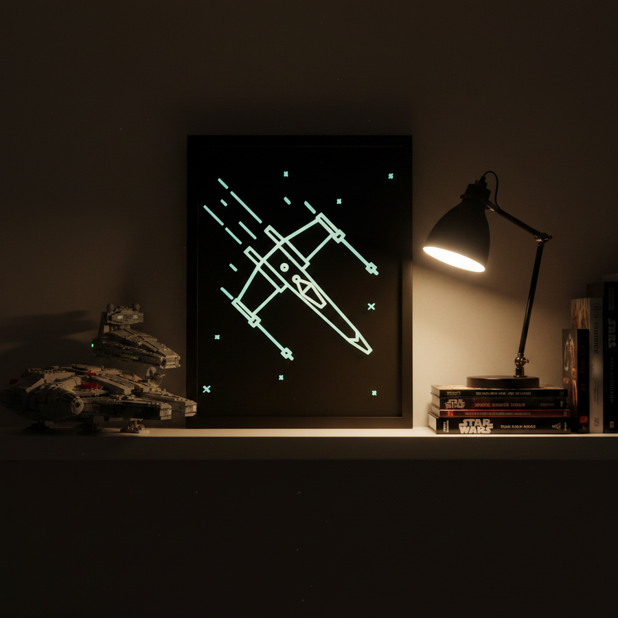 X-Wing neon line art shadow box on a bedroom shelf beside Star Wars Lego sets showing glow-in-the-dark effect