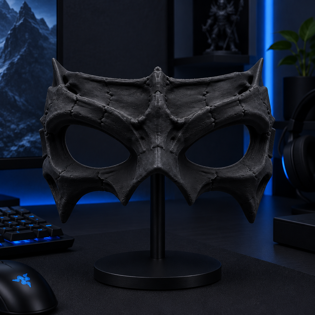 Black Bone Wraith Mask displayed on a stand at a gaming setup.