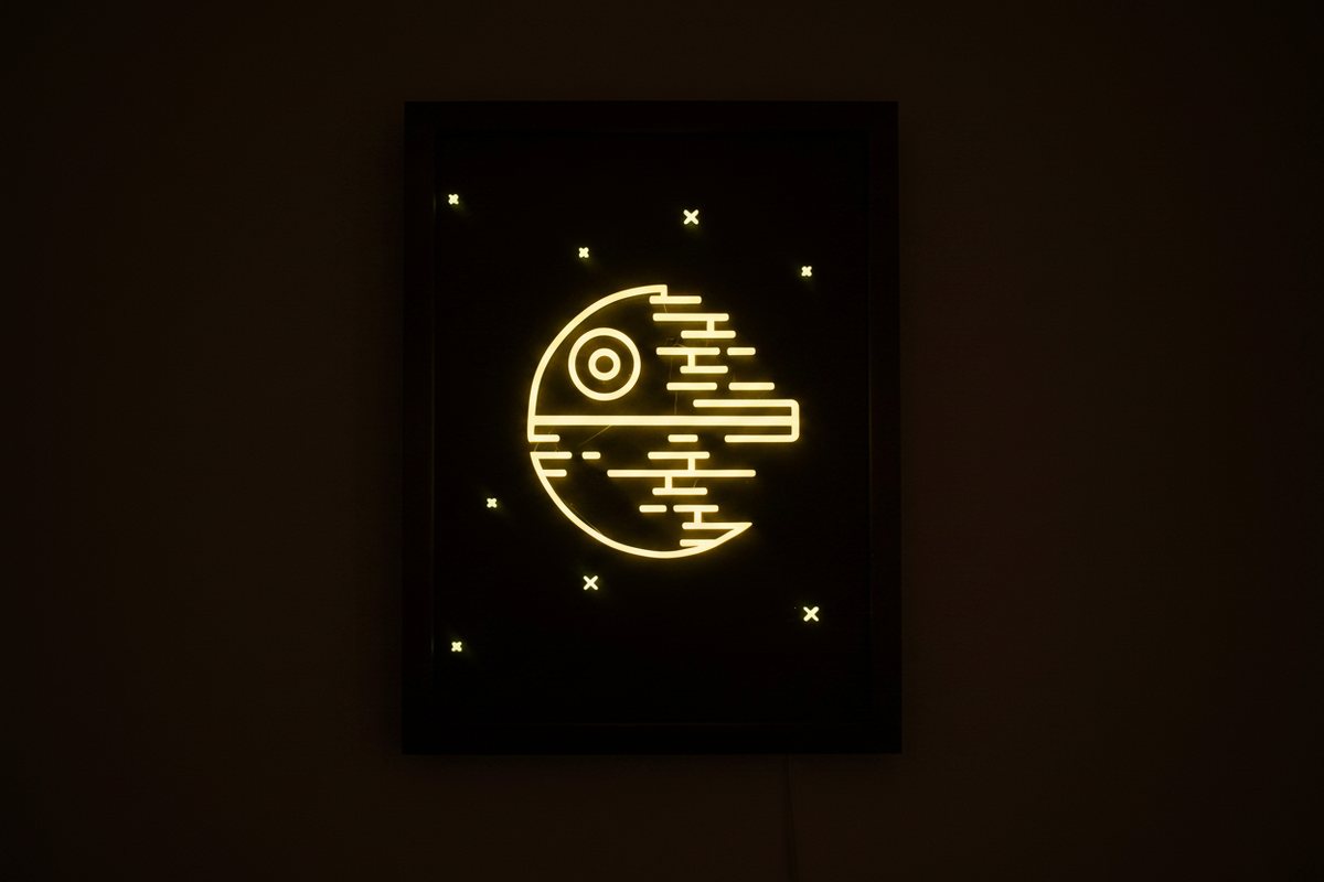 Death Star Neon Line Art shadow box glowing in the dark with vivid ominous yellow Imperial control panel glow and glowing star markers
