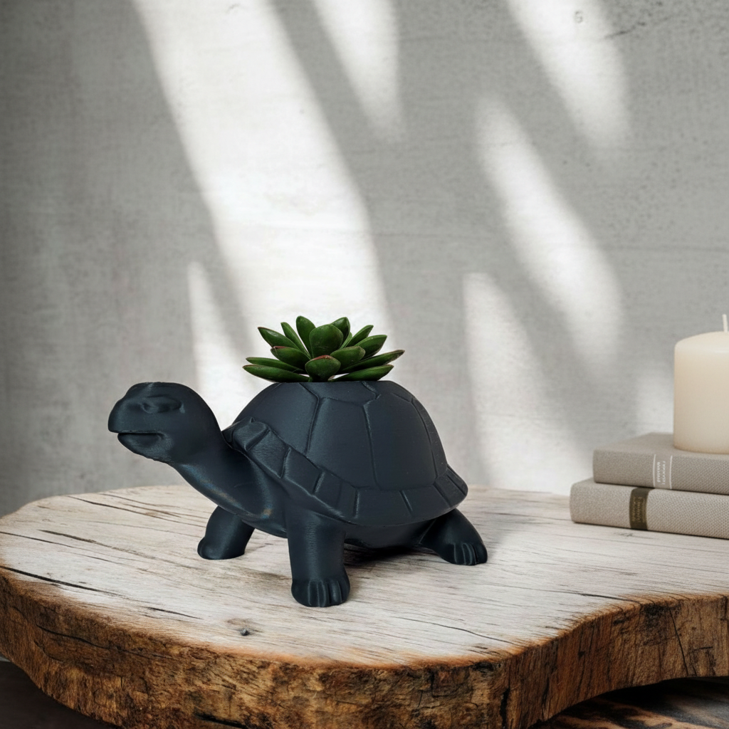 Matte black turtle planter with a succulent on a wooden log slice in a cosy Scandinavian interior