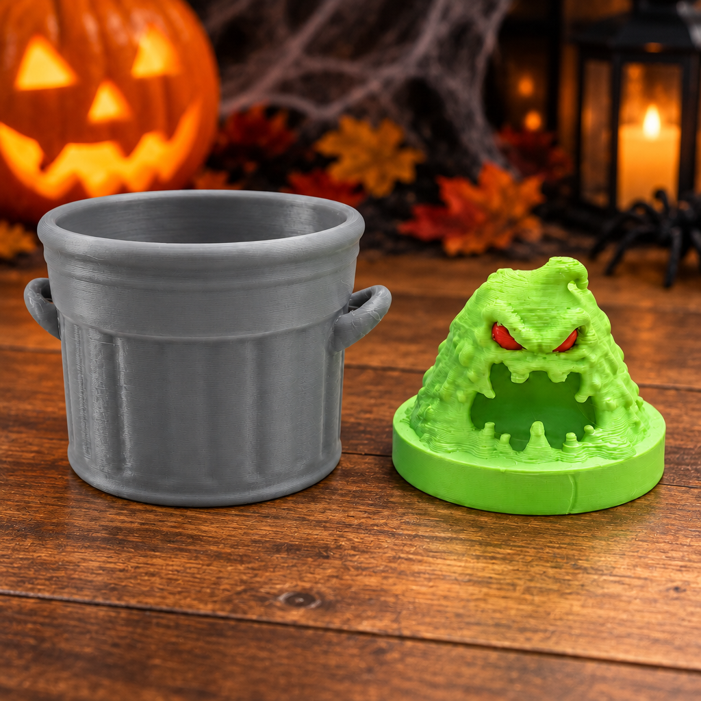 Slime monster and bin shown separately on wooden table