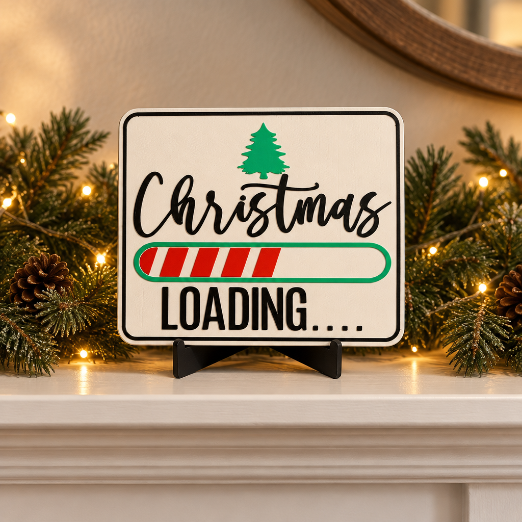 Christmas Loading Sign on a mantel with evergreen and warm lights