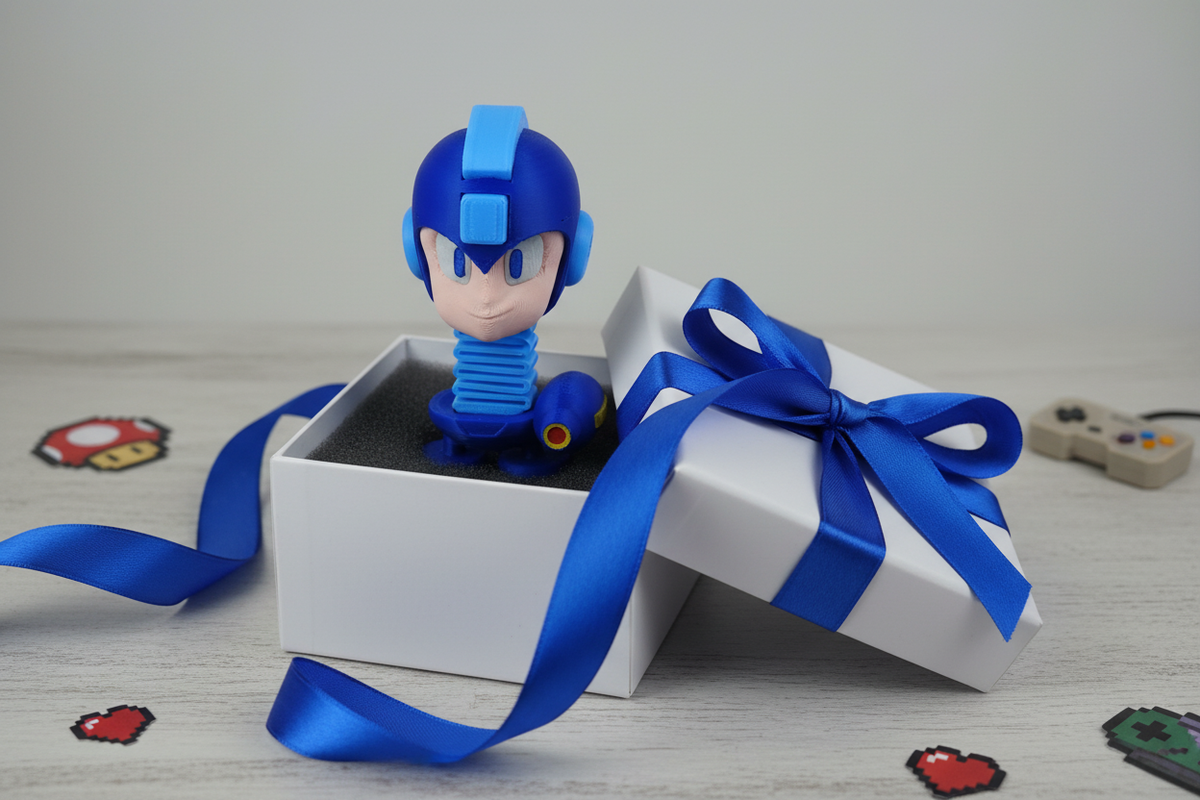 Mega Man Springie 3D printed figure presented as a gift in a white box with blue ribbon and gaming themed decorations
