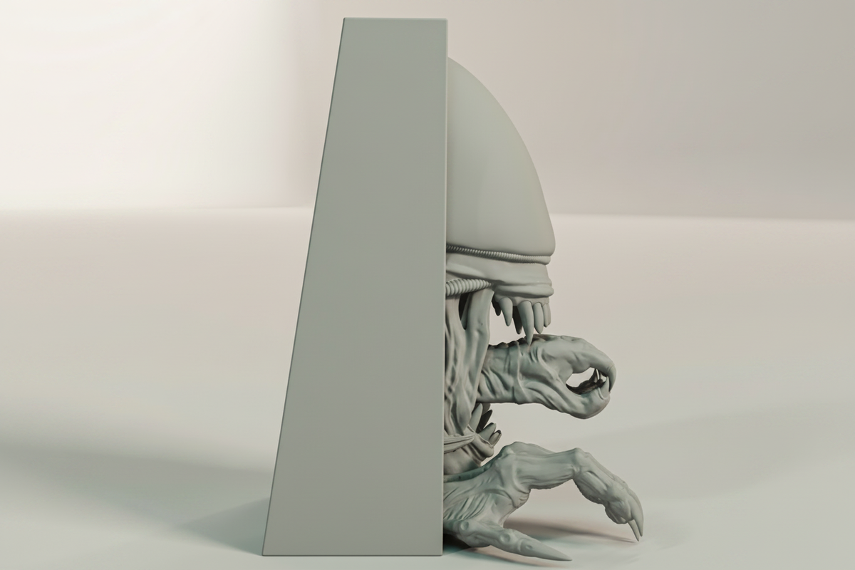 Alien Xenomorph book nook relief sculpture grey framed box side profile close up full three dimensional depth elongated dome cranium rising above frame biomechanical neck clawed hands extending beyond frame neutral studio raking side light landscape editorial