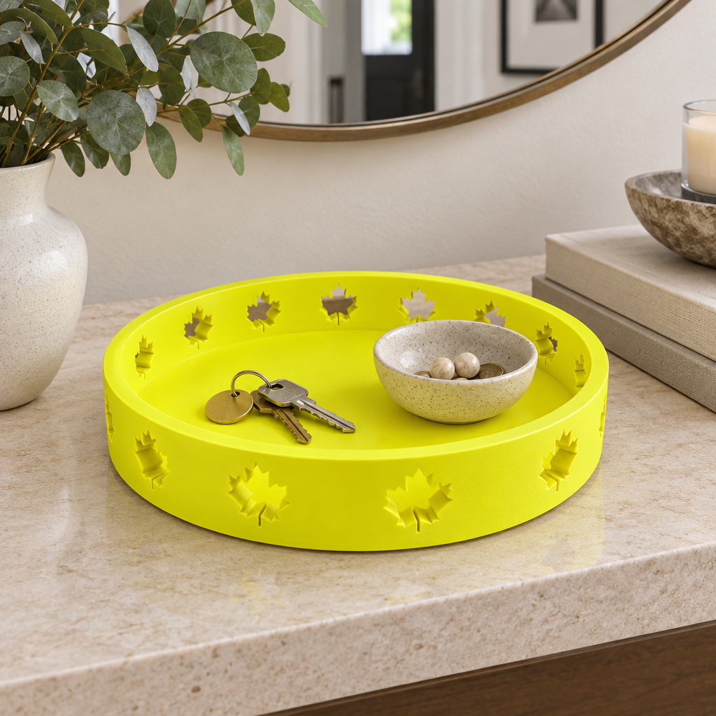 Solid neon-yellow round Autumn Tray with maple-leaf cutouts on a hallway console