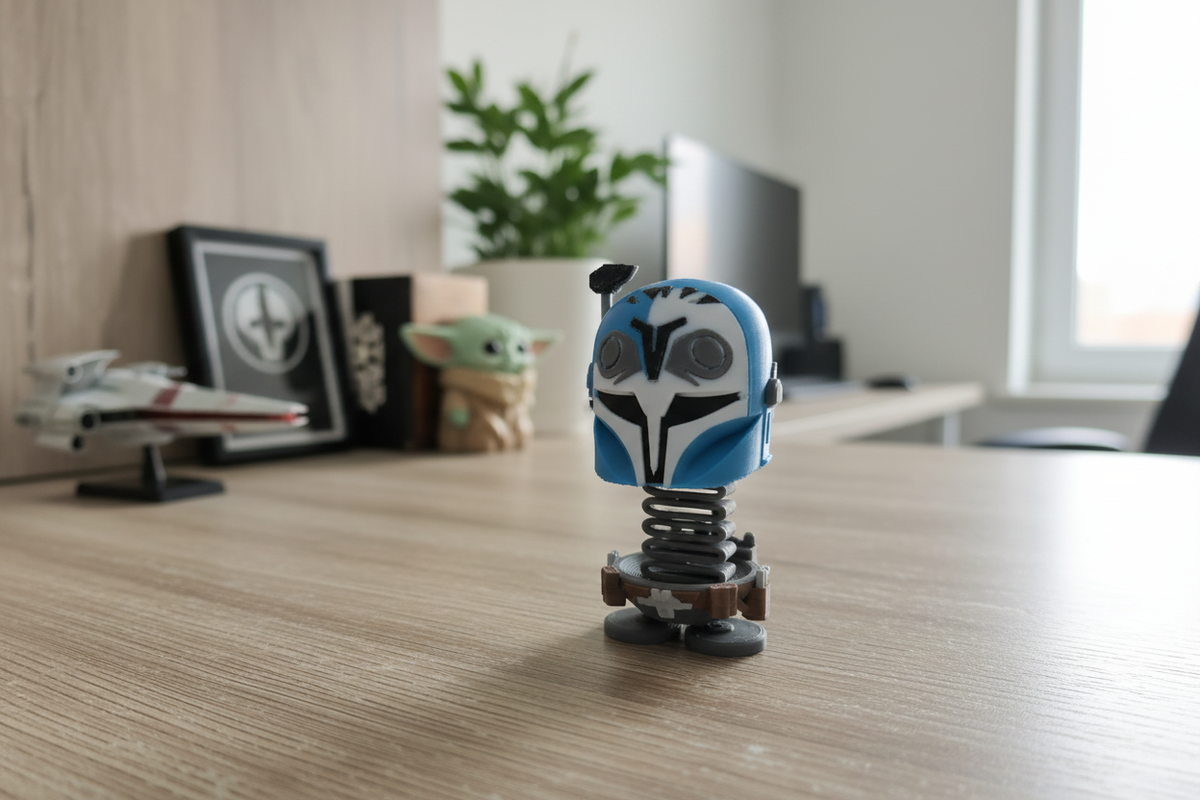 Star Wars Bo-Katan Kryze Springie on a wooden desk in a bright modern home office with Star Wars collectibles