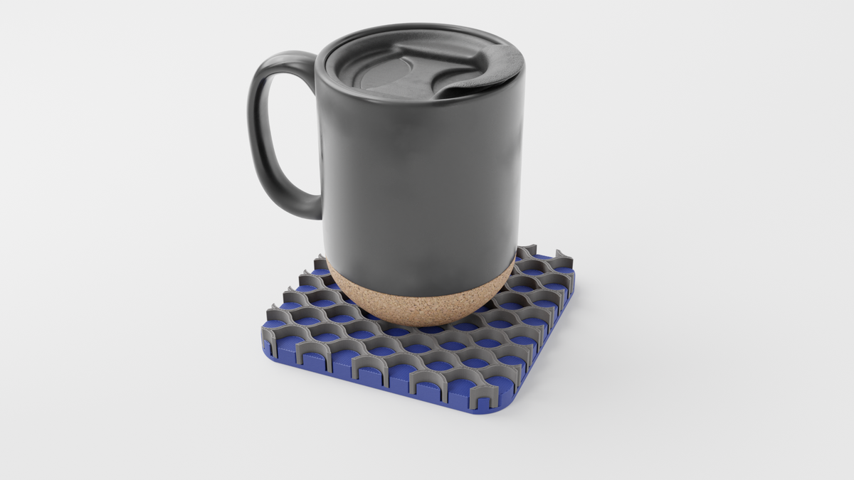 Black mug resting on a grey and blue Triple Interlocking Coaster Set