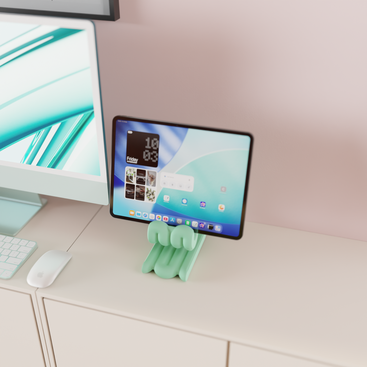 Wibble iPad Stand mint green on sideboard beside iMac with warm overhead spotlight evening home office render lifestyle