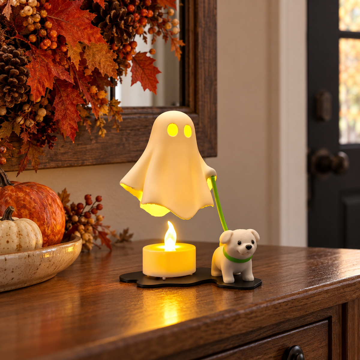 White ghost walking a small dog with a red lead on a shelf beneath Halloween bat decorations