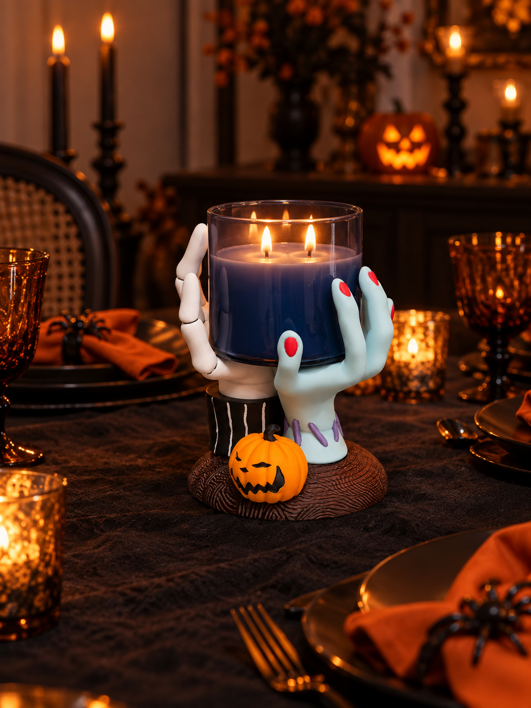 Hands Candle Holder styled with a lit candle, pumpkins and Halloween table decorations