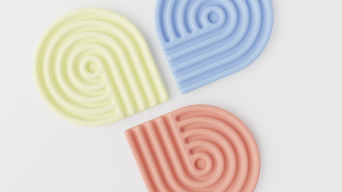 Yellow, blue and coral looped coasters arranged in a fan