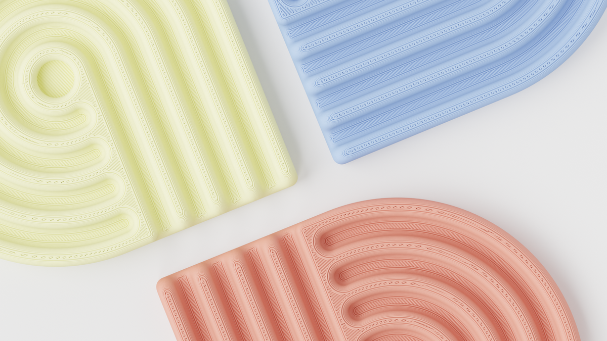 Close-up of pastel looped coasters in yellow, blue and coral