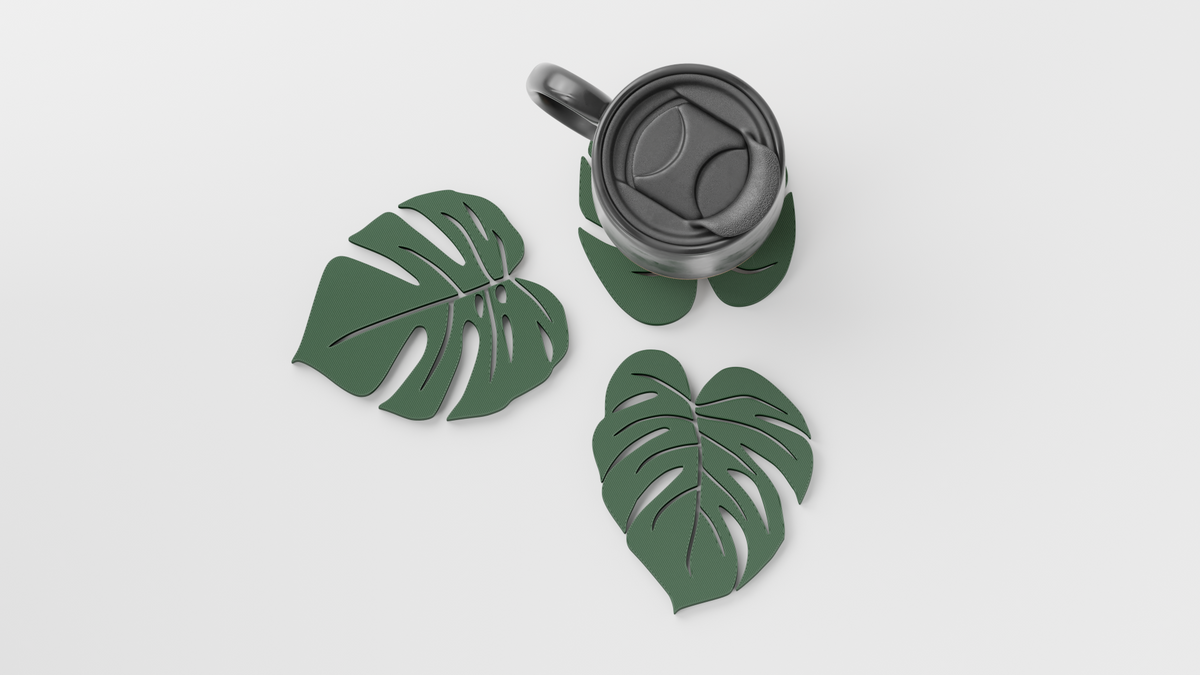 Sage green monstera leaf coasters with a mug and travel cup