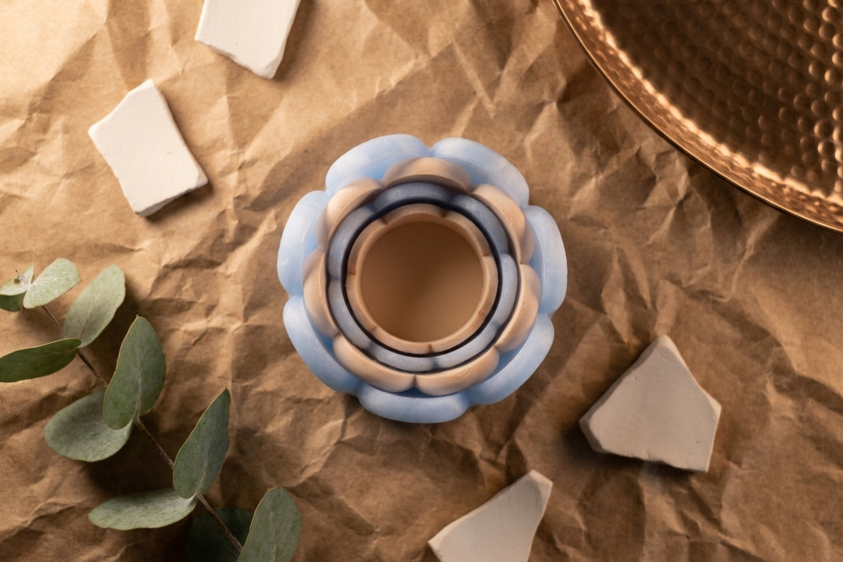 Blue wibble nested trays floating against warm terracotta background with geometric shapes editorial render