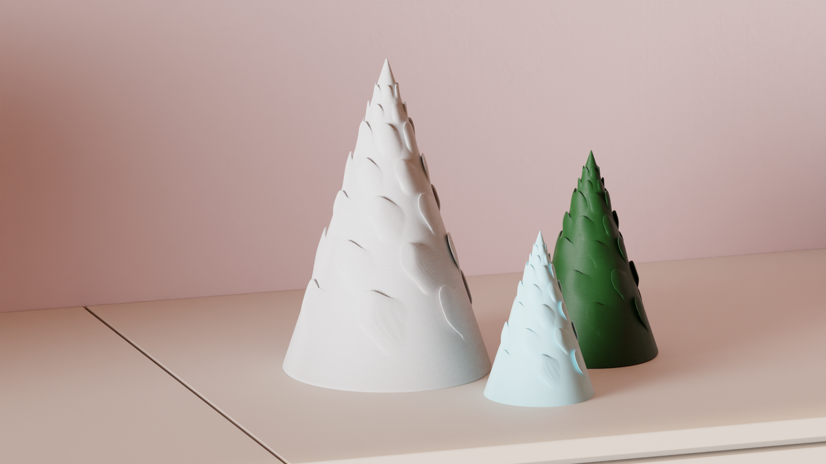 Set of three Spiral Branch Christmas Trees arranged on a minimalist cabinet