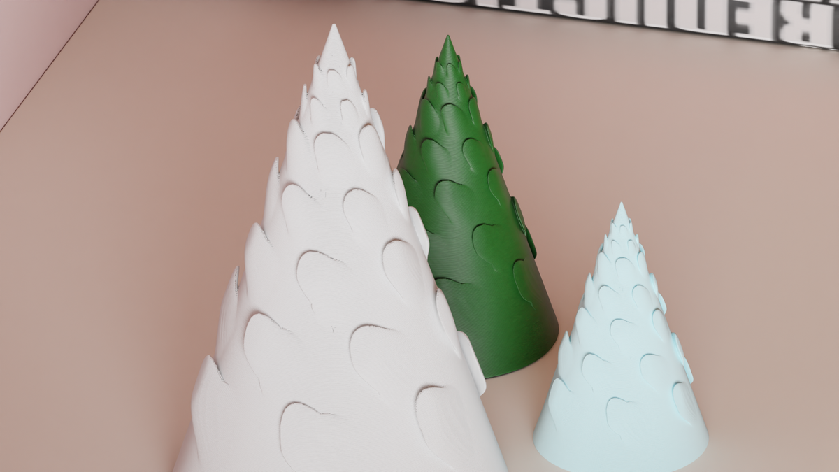Close-up of the raised spiral branch detail on three Christmas tree decorations