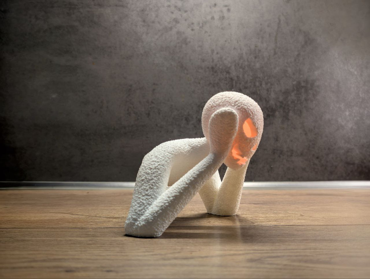 Side view of the textured white NOBODY LANTERN with glowing face
