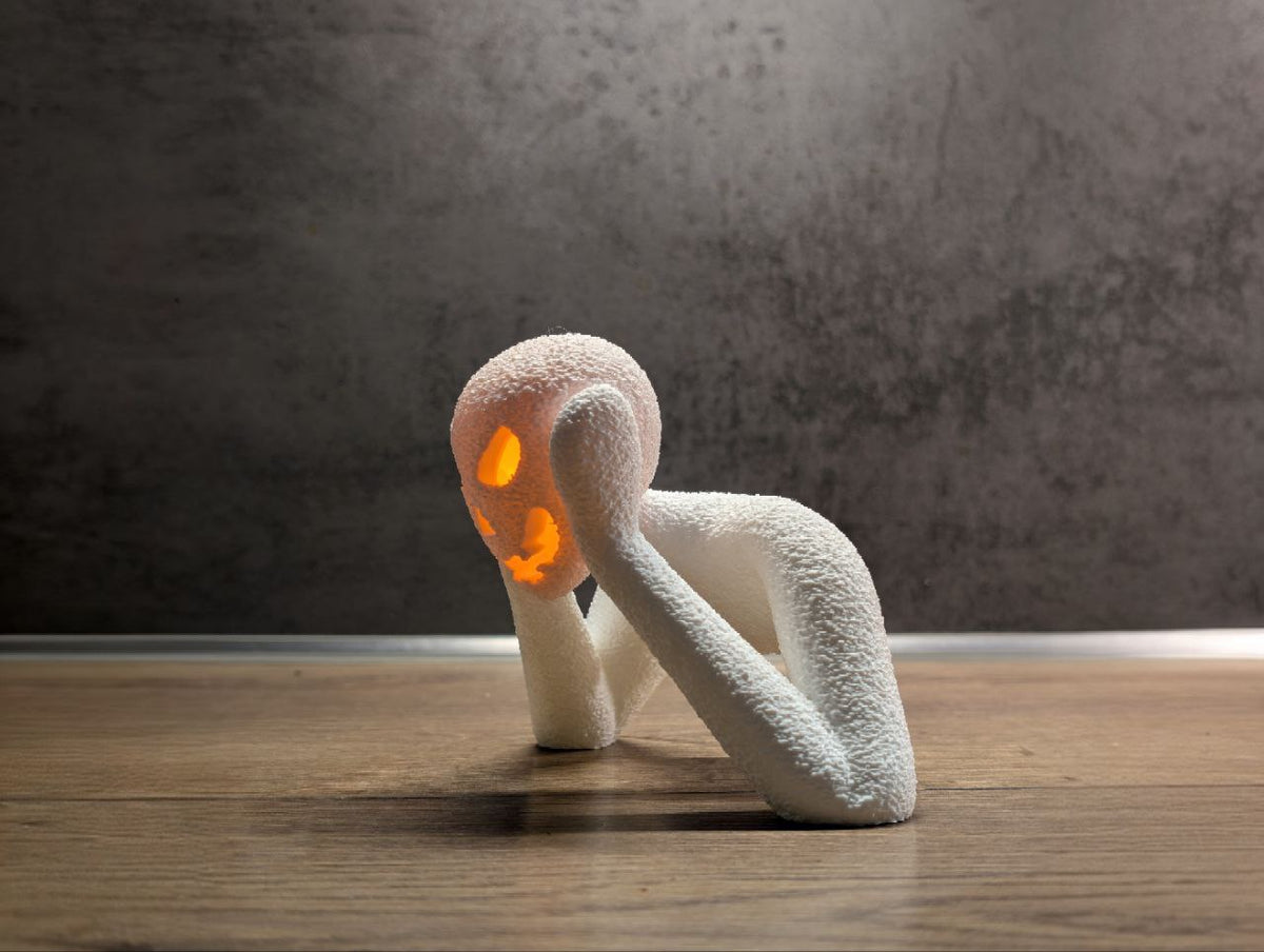 Angled view showing the long arms and illuminated pumpkin face of the NOBODY LANTERN