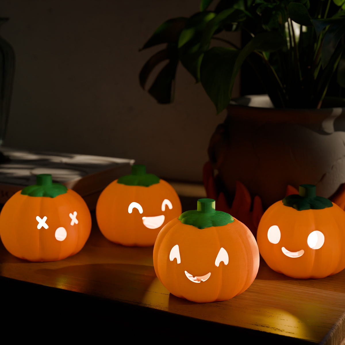 Four pumpkin lantern designs with green tops and bases