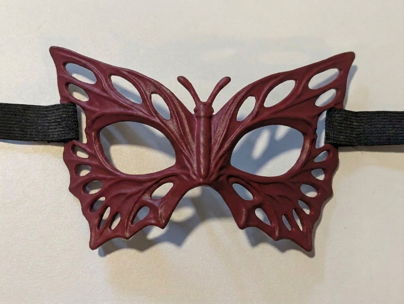 Red Butterfly Mask product photo with raised veins and large open eyeholes; strap not included.