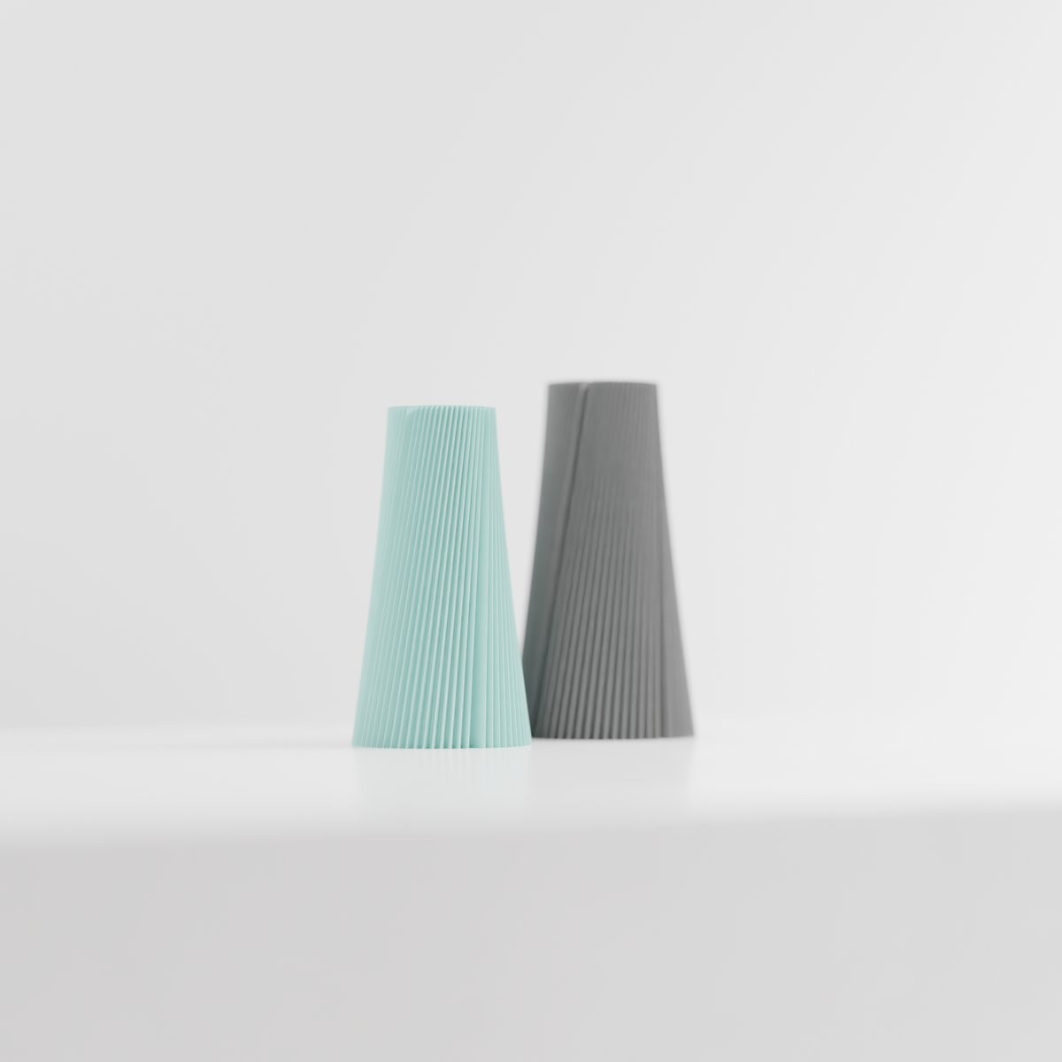 Pleated Cone Vase mint green on pale oak sideboard beside framed art and monstera