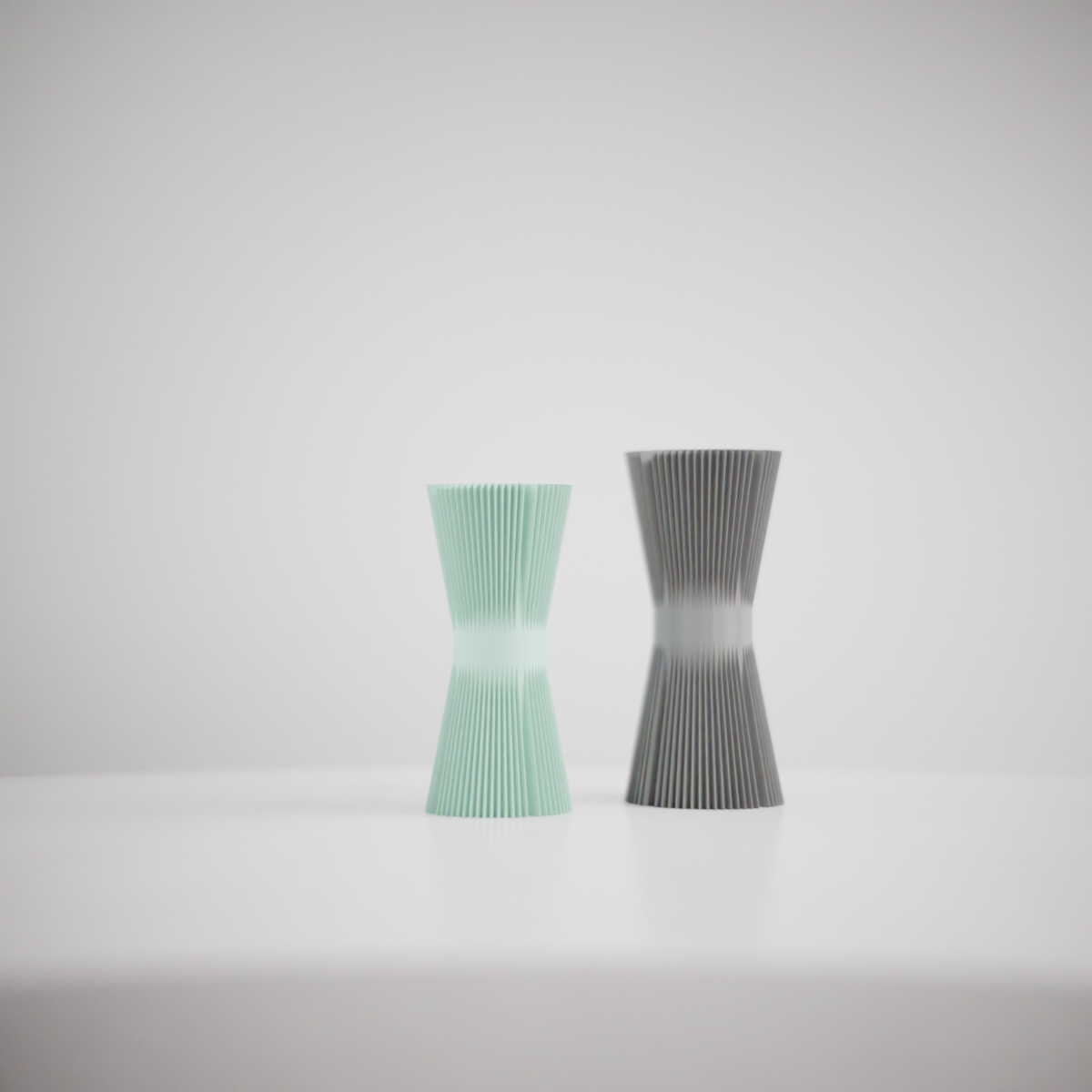 Ripple Twist Vase slim hourglass profile tight vertical ribbed ripple texture mint green single vase on white surface white background close editorial studio shot