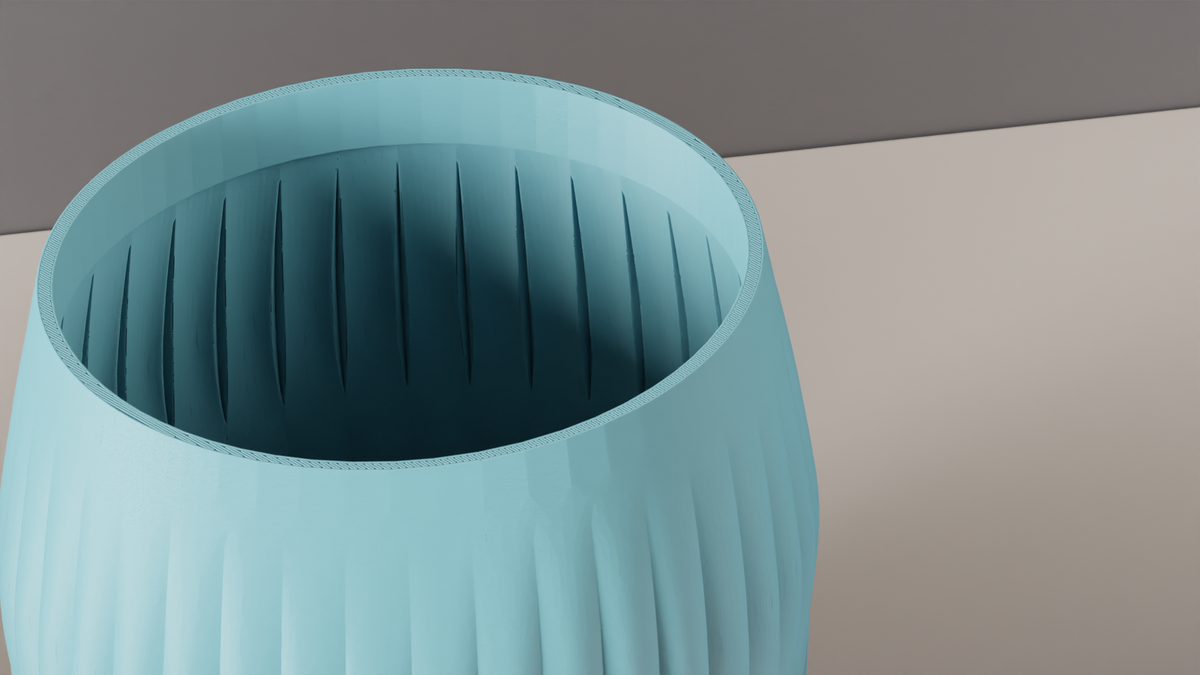Close-up of the open rim and vertical ripples on a blue Ripplied Barrel Vase