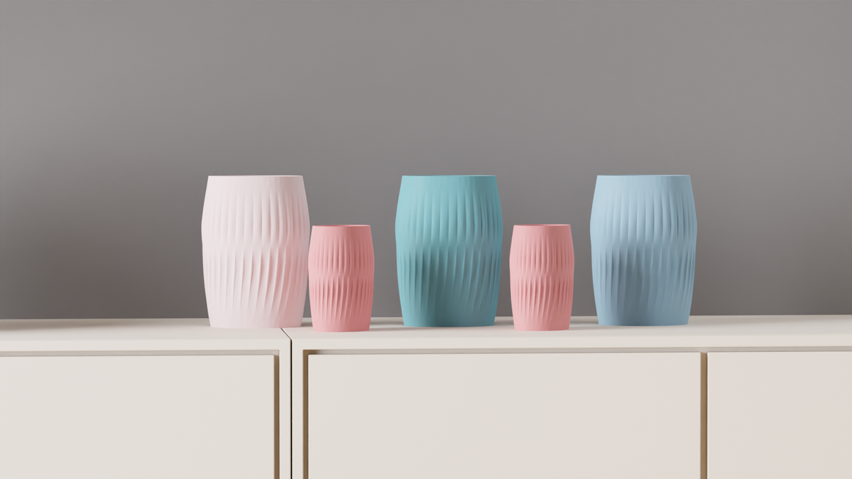 White, pink and blue Ripplied Barrel Vases styled across a shelf