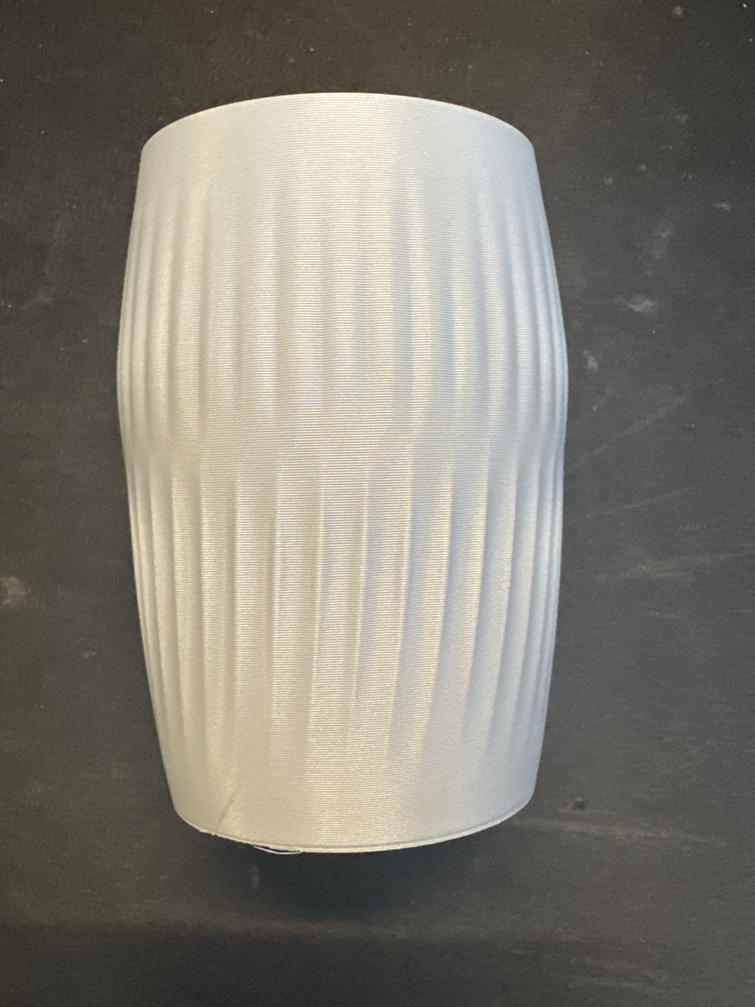 White Ripplied Barrel Vase shown upright against a dark background