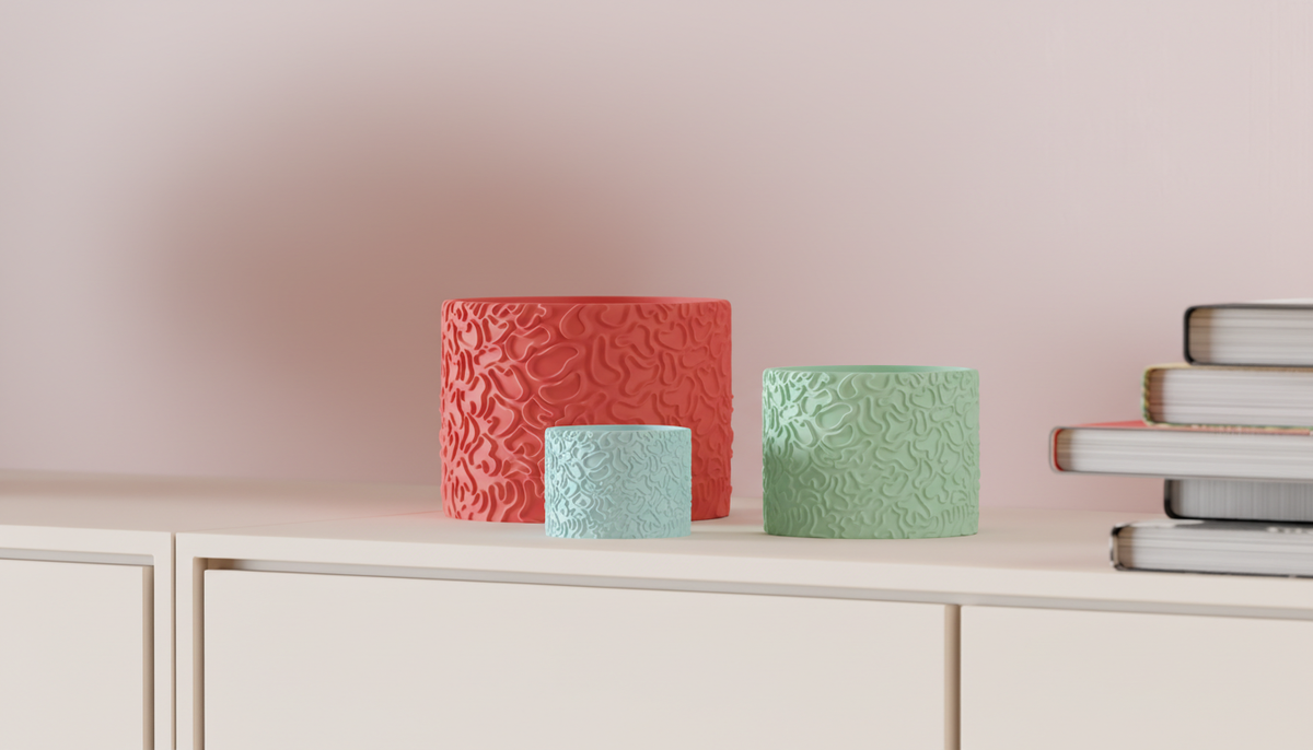 Coral Pattern Planter coral red mint green light blue knolling flatlay overhead monstera leaf eucalyptus white dish pebble gold wire concrete surface