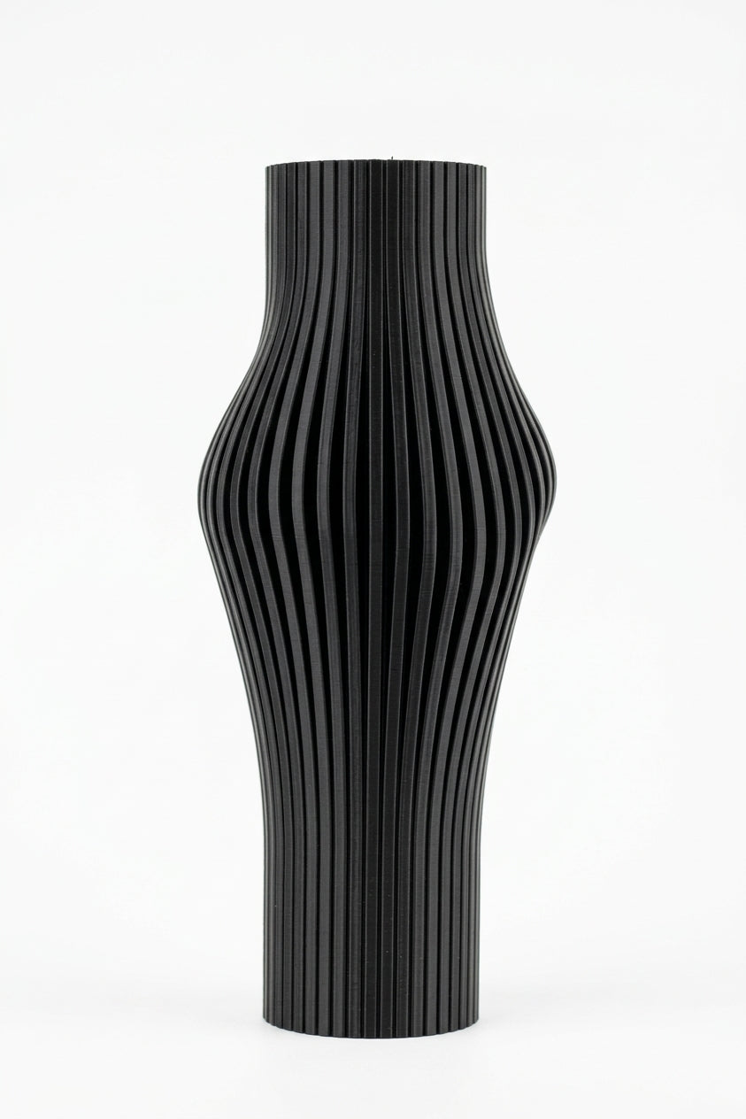 Elegant Sculpted Ribbed Vase black on travertine with monstera palm leaves bright natural light