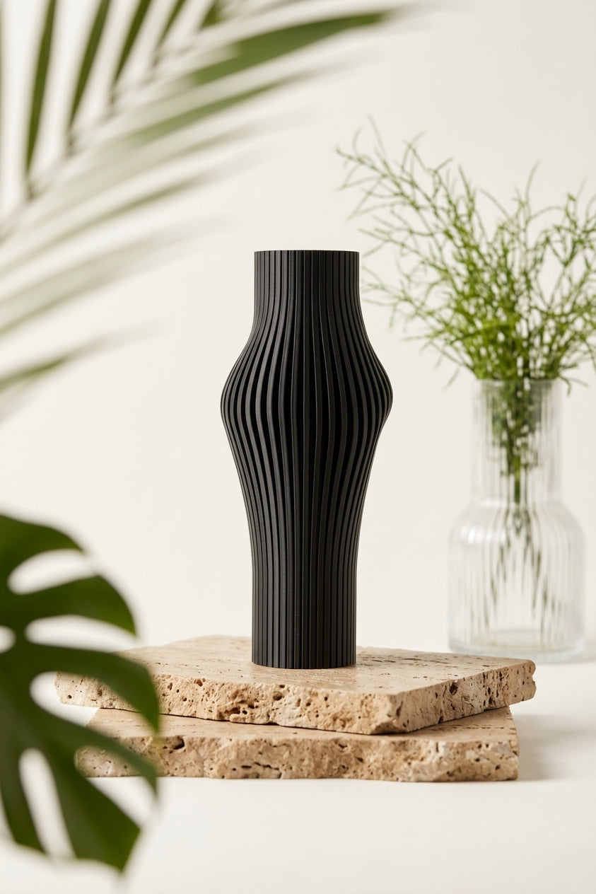Elegant Sculpted Ribbed Vase black angled view showing curvaceous waist and ribbed surface