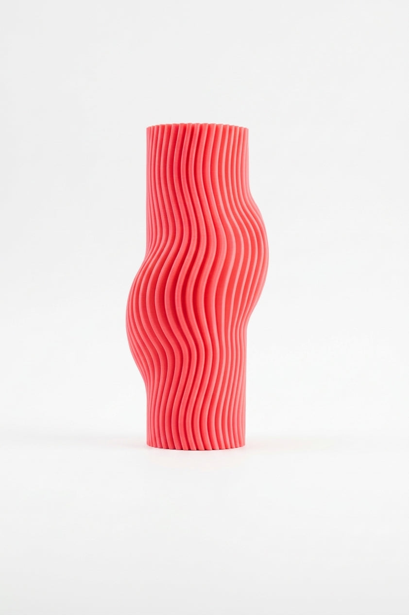 Elegant Ribbed Flow Vase pink on travertine stone slabs with monstera and fern leaves botanical lifestyle