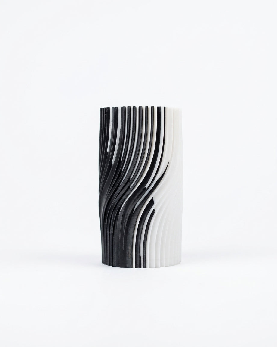 Black and white ribbed vase on dark background