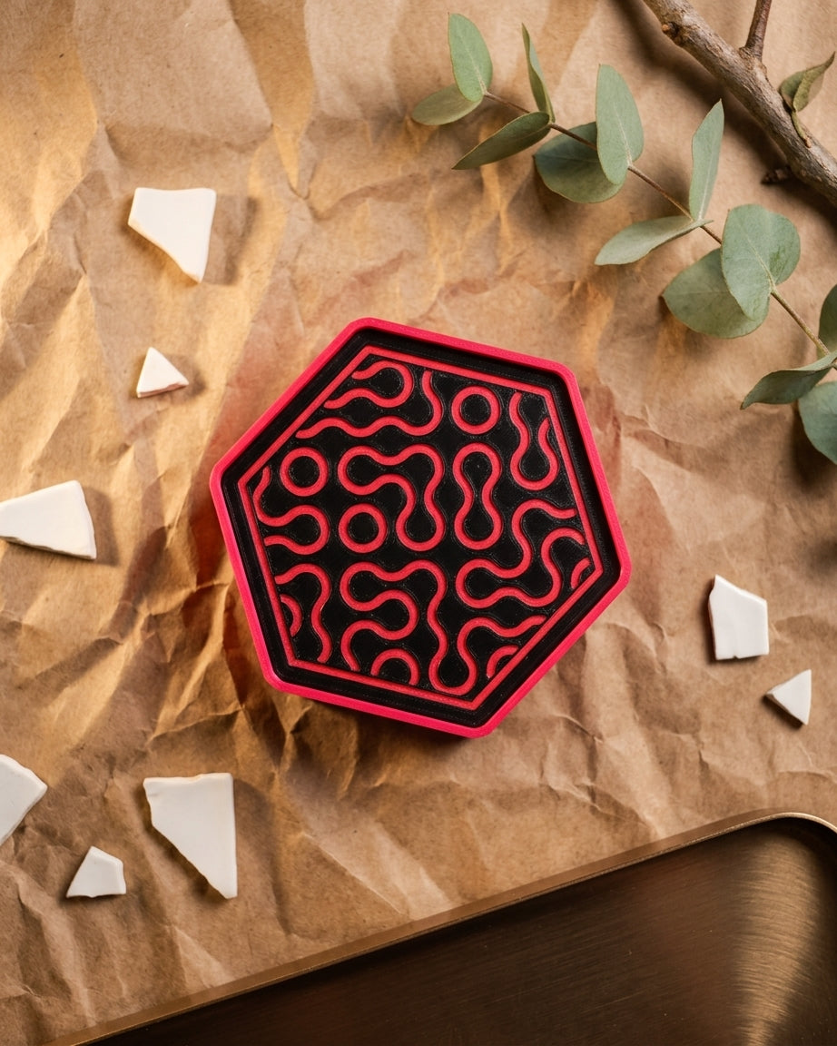 Four Truchet hexagonal coasters arranged next to holder