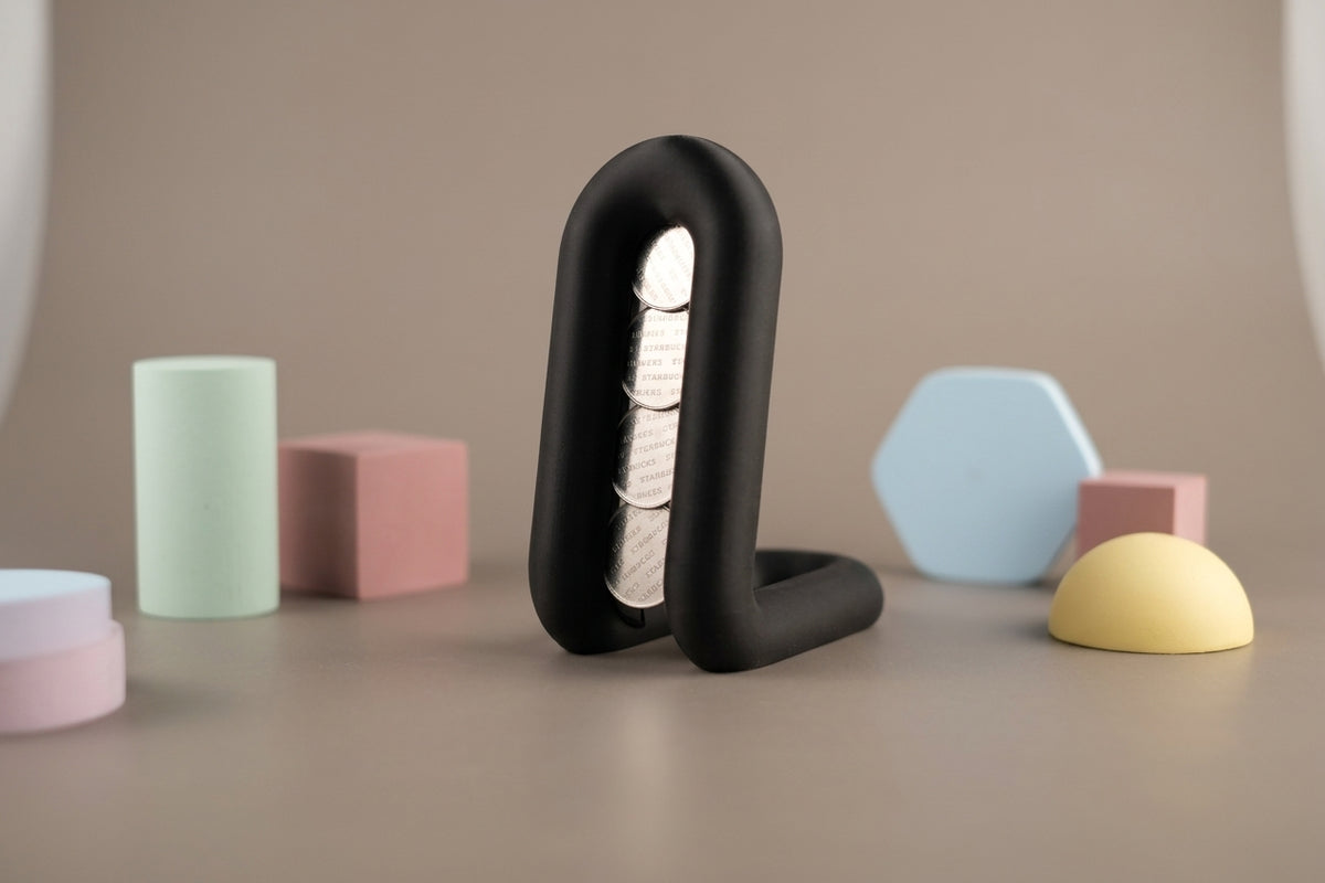 Wibble coffee pod holder render three quarter view showing pod channel and loop base