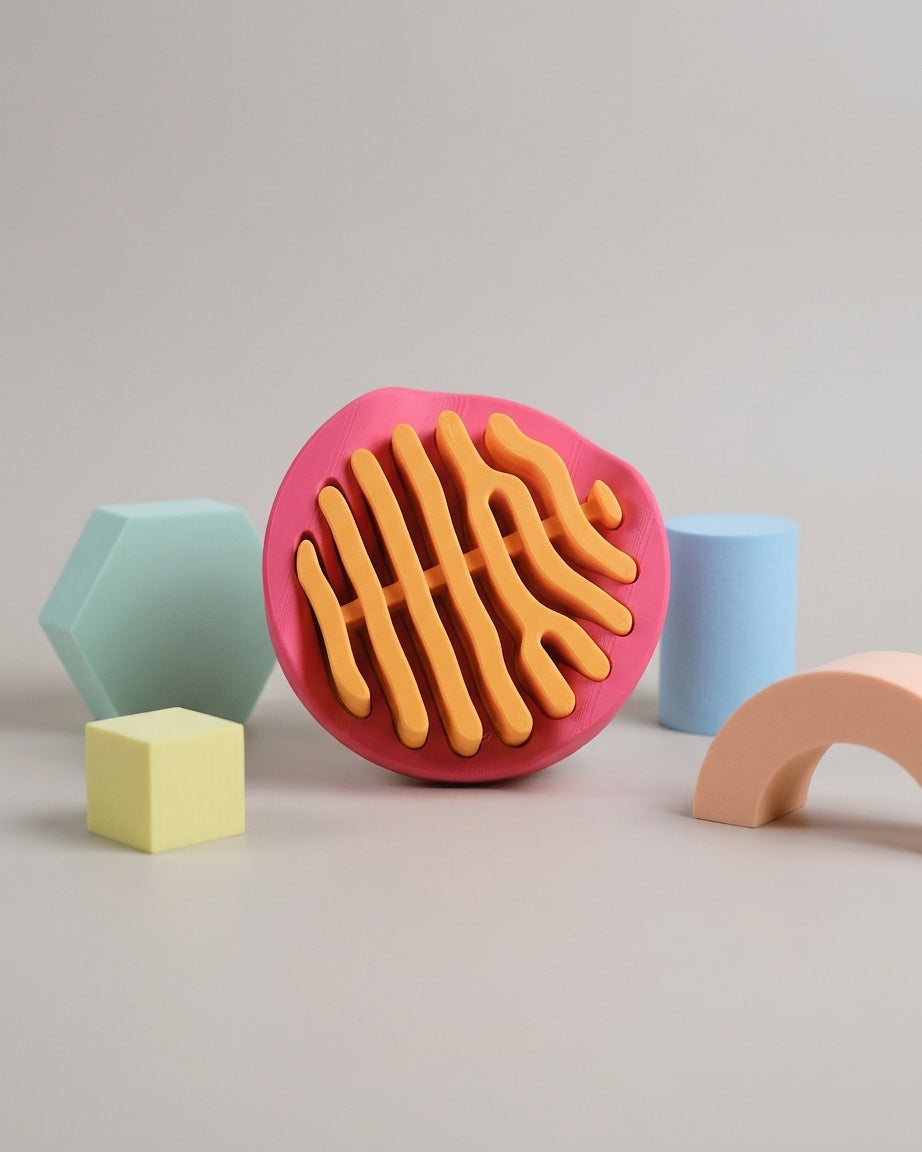 Side view of coral coaster set in pink stand