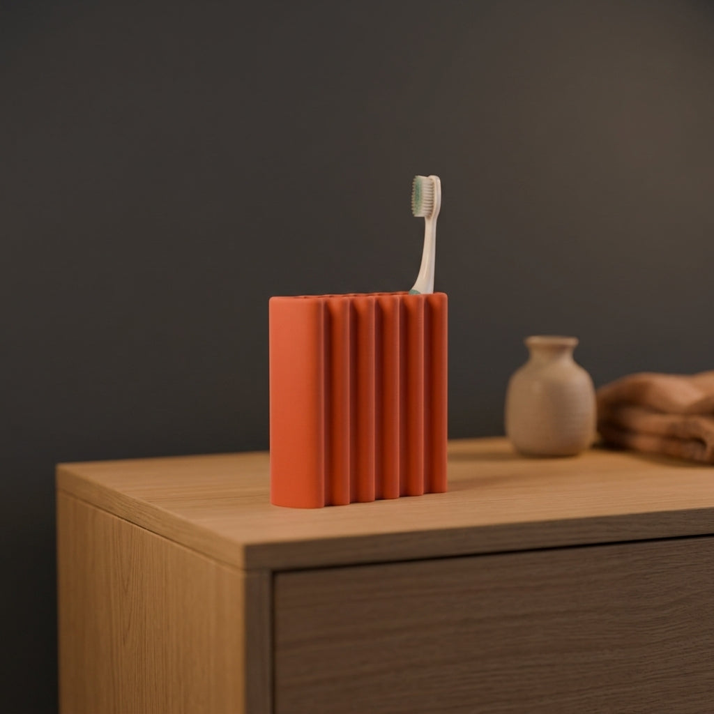 Grey ripple toothbrush holder showing wavy ribbed side profile close up